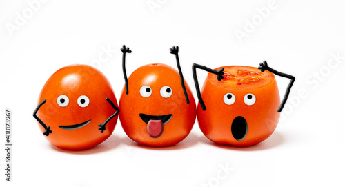 Obraz na plátne 3 cheerful anthropomorphic tomatoes with expressive faces on a white background