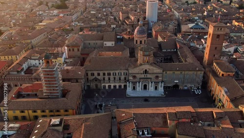 reggio emilia aerial view drone of city centre piazza prampolini tilt up revealing cityscape at sunrise dawn photo