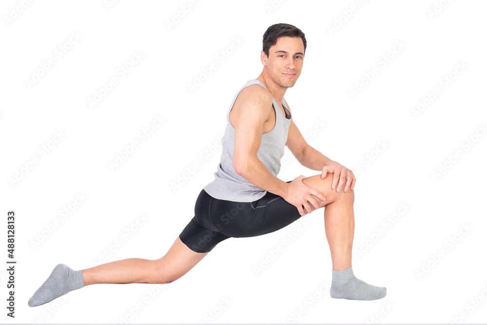 Positive sportsman doing stretching exercise in studio Positive sportsman doing stretching exercise in studio