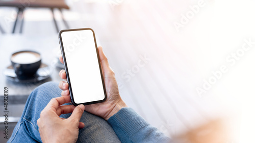 cell phone blank white screen mockup.hand holding texting using mobile on desk at office.background empty space for advertise.work people contact marketing business,technology