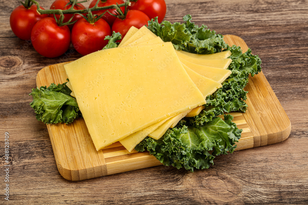 Sliced Gauda cheese over board Sliced Gauda cheese over board