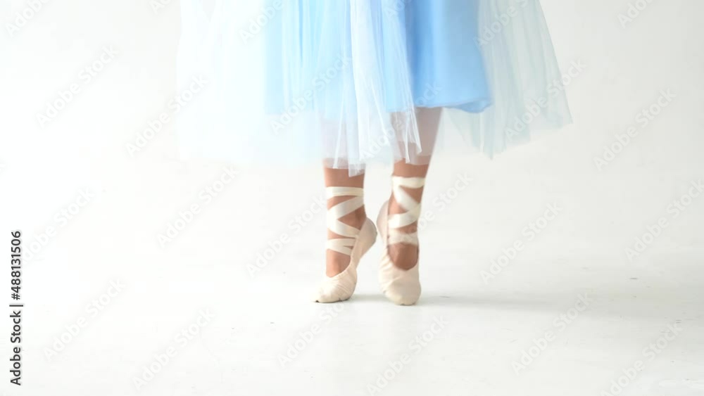 Ballet choreographer. Dance in pointe shoes on the socks close-up. Ballerina training in the dance class. Ballet choreographer. Dance in pointe shoes on the socks close-up. Ballerina training in the dance class.