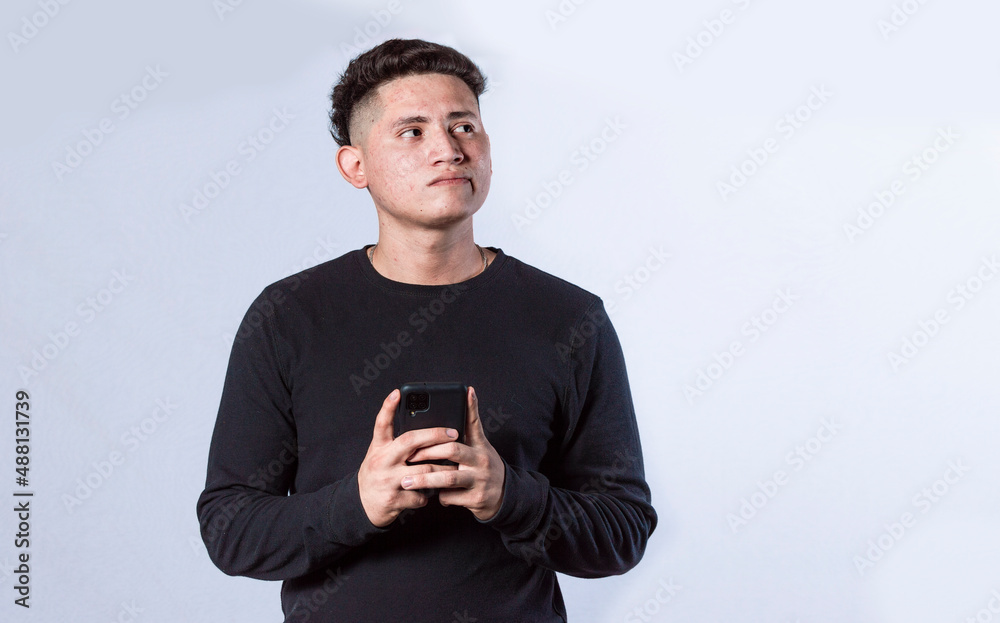 thoughtful man with cell phone in hand, handsome latin guy thinking with cell phone in hand thoughtful man with cell phone in hand, handsome latin guy thinking with cell phone in hand