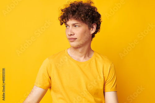 guy with red curly hair yellow t-shirt fashion hand gestures isolated background unaltered