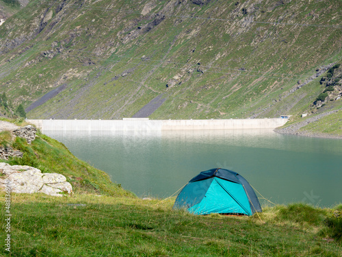 Tourist tent among a mountain meadow and a lake. Freedom and in solitude holidays. Natural contest. Relaxing time. Summer. General contest © Matteo Ceruti