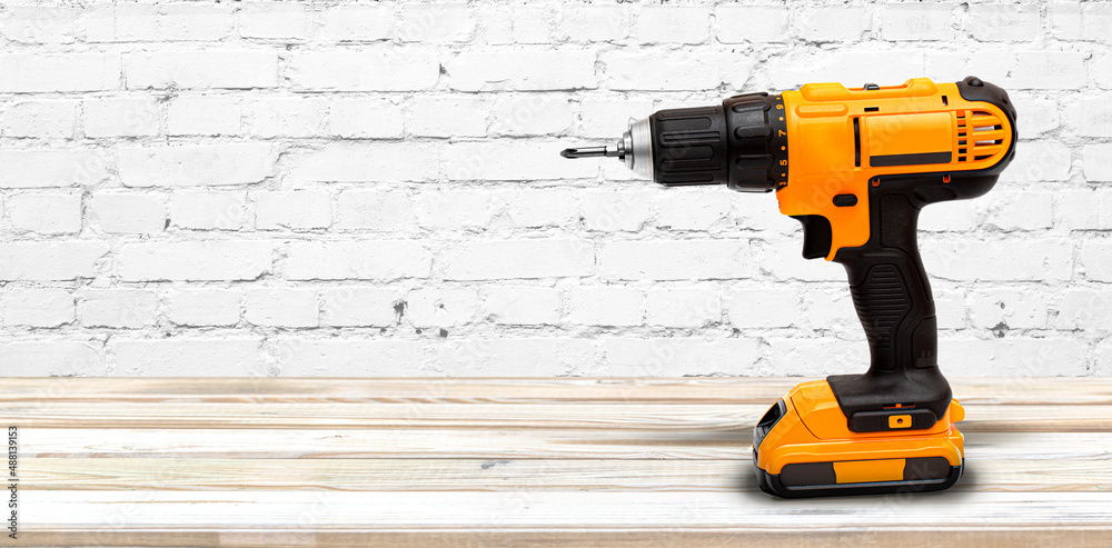 Yellow electric cordless screwdriver drill