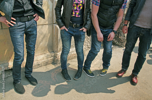 Four young guys in fashionable clothes