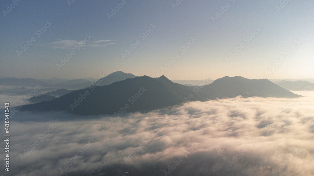 Sea of Fog covers the area on the top of hill Doi Phu Thok, Chiang Khan, Loei, Thailand with background of sunrise on winter. 