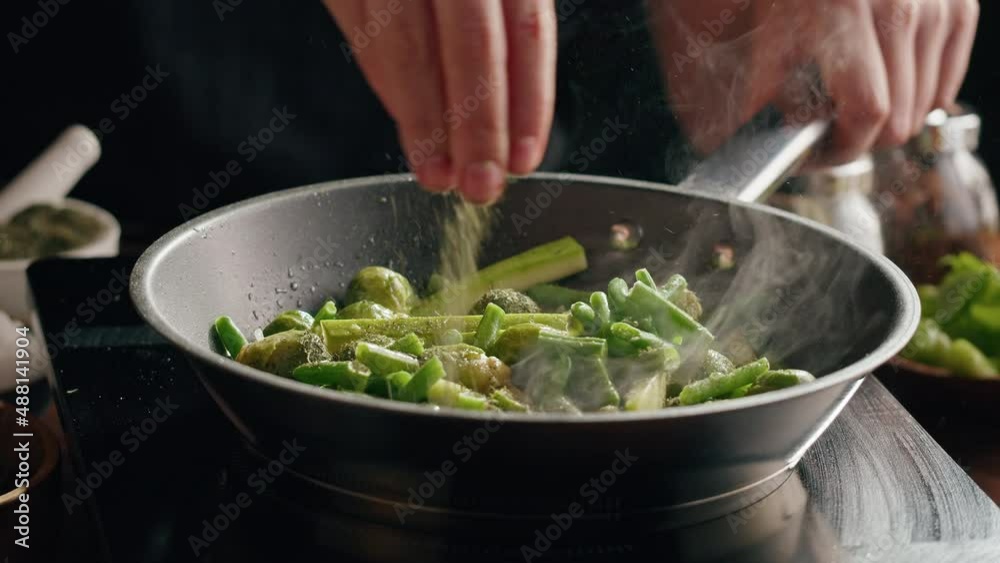 Chef frying green brussels sprouts, cabbage in pan close-up. Woman chief cooking dish with grilled vegetables, vegetarian food. Healthy eating concept. Chef frying green brussels sprouts, cabbage in pan close-up. Woman chief cooking dish with grilled vegetables, vegetarian food. Healthy eating concept.