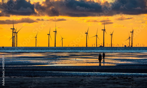 Wind turbines off the coast at Crosby near Liverpool, UK. photo