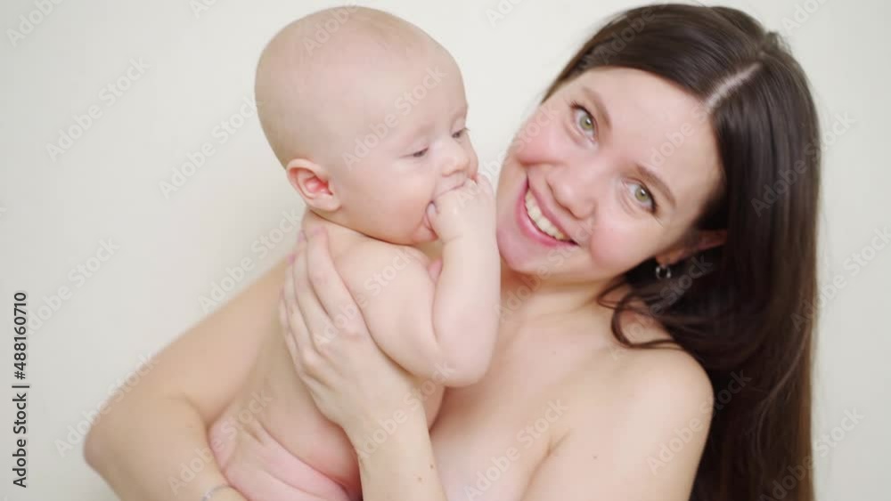 beautiful and gentle naked mom and baby. happy childhood and motherhood. beautiful and gentle naked mom and baby. happy childhood and motherhood.