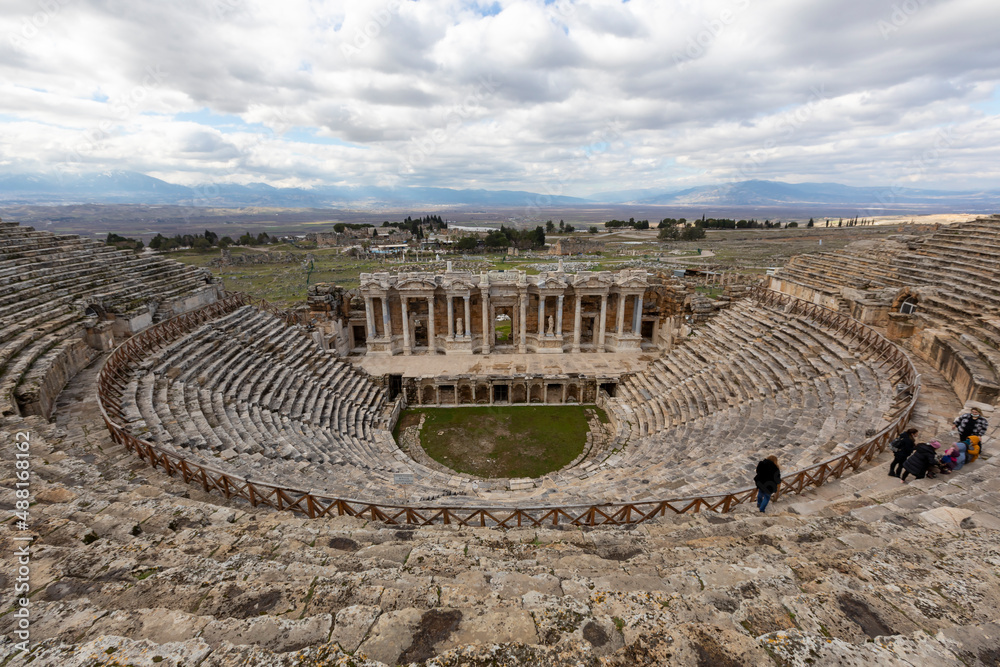 Amphitheater in ancient city of the Hierapolis. Dramatic sunset sky. Unesco Cultural Heritage Monument. Pamukkale, Turkey