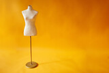 white mannequin on yellow background