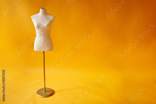 white mannequin on yellow background photo