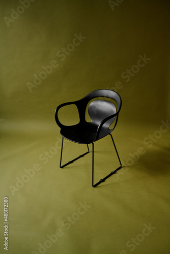 black chair on olive green background