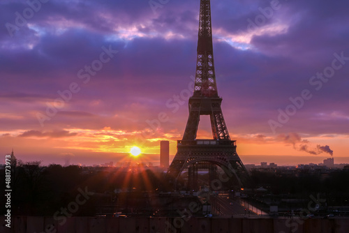 Urban landscape. Silhouette of Eiffel tower with dramatic sky in the background. Sunrise or sunset over the city of Paris.