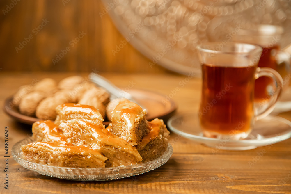 Baklava with nuts on a wooden background. Selective focus.