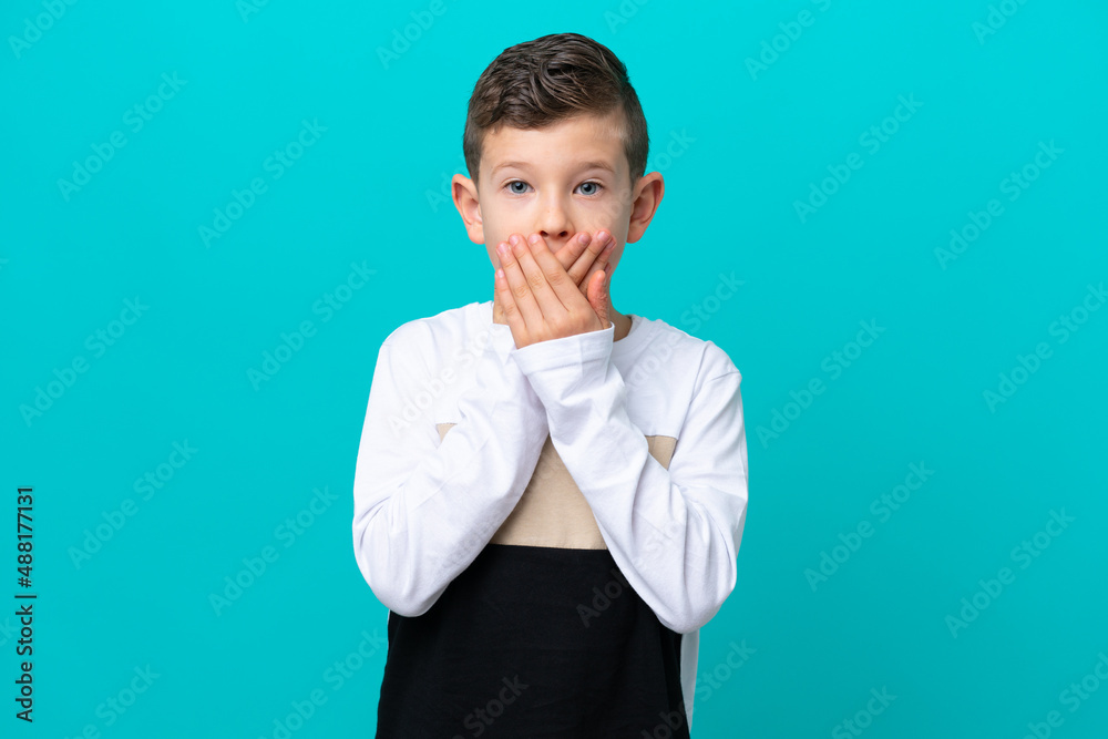 Little kid boy isolated on blue background covering mouth with hands Little kid boy isolated on blue background covering mouth with hands