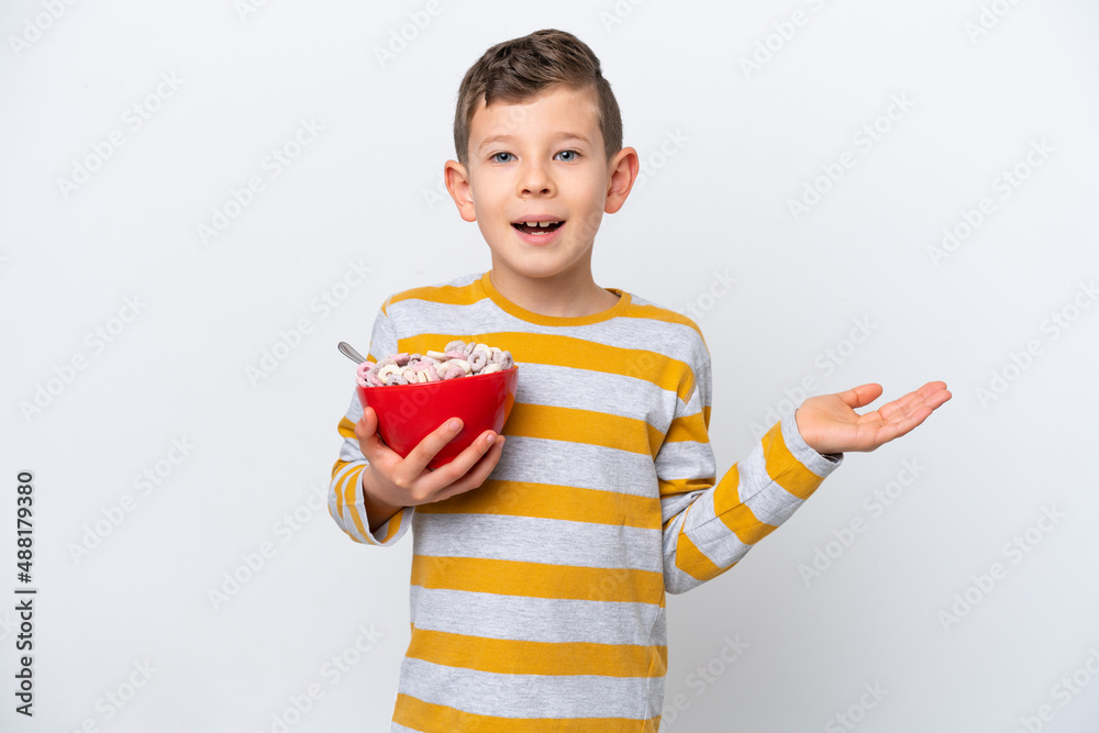 Little caucasian boy holding a cereal bowl isolated on white background with shocked facial expression Little caucasian boy holding a cereal bowl isolated on white background with shocked facial expression