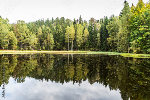 Fototapeta Naklejka Na Ścianę i Meble -  Lake with forest with rock formation mirroring on waterground