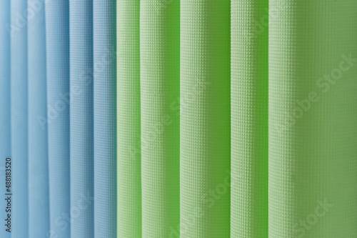 Lots of yoga mats in blue and green. Background for the inscription.