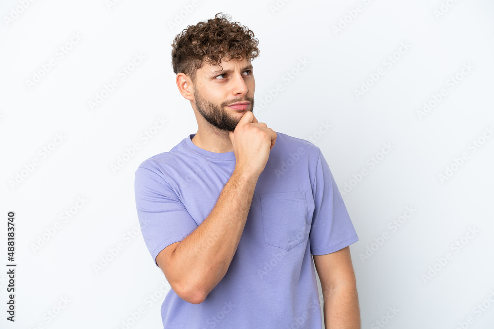 Young handsome caucasian man isolated on white background and looking up Young handsome caucasian man isolated on white background and looking up
