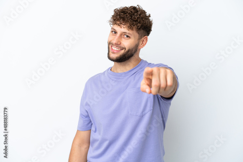 Young handsome caucasian man isolated on white background pointing front with happy expression