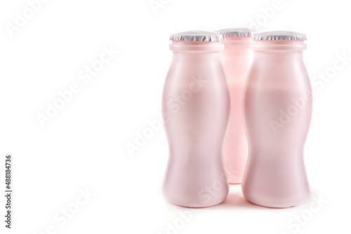 Three bottles of milk yogurt (kefir) on a white background. The concept of probiotics (bifidobacteria) and healthy nutrition. Space for text. Packaging of fermented milk products.