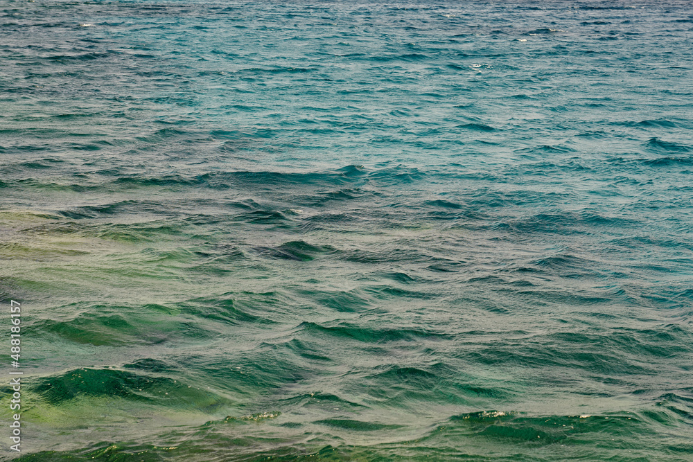 Waves on the surface of the turquoise tropical sea.
