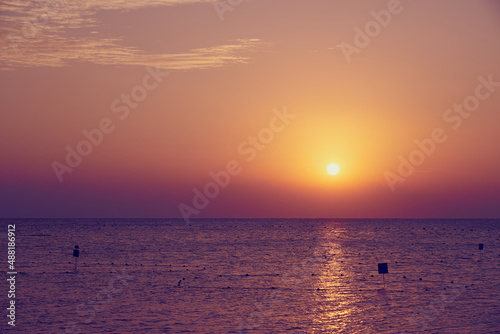The sun rises over the Red Sea at dawn.