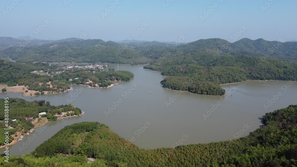 Area of Huai Krathing reservoir for Rafting and Eating at Loei Province, Thailand. Beautiful natural landscape of the river, mountain, blue sky with green forest and bamboo raft shelter. Area of Huai Krathing reservoir for Rafting and Eating at Loei Province, Thailand. Beautiful natural landscape of the river, mountain, blue sky with green forest and bamboo raft shelter.