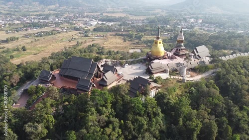 Wat Somdet Phu Ruea Ming Mueang Temple 4k fly over aerial view. Temple is built with fine wood timber. The church is made of teak and locate on mountain and best viewpoint at Phu ruea, Loei, Thailand photo