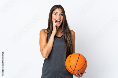 Young brazilian woman playing basketball isolated on white background with surprise and shocked facial expression © luismolinero