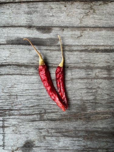 Dried red chilli on brown wood background
