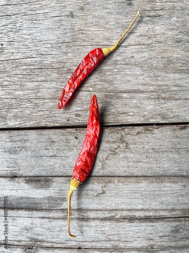 Dried red chilli on brown wood background