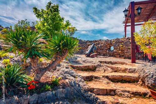 Old cannon on the stone wall in Petrela Castle. Picturesque spring scene of Albania, Europe. Traveling concept background. photo