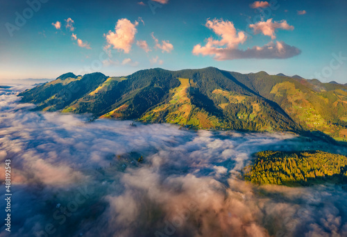 Aerial landscape photography. Spectacular sunrise on Carpathian mountains. Fog spreads on the valley of Snidavka village  Ukraine  Europe. Beautiful landscape of mountain hills.