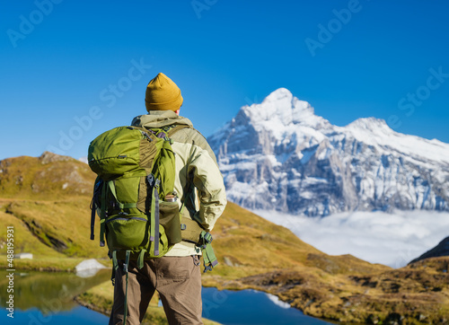 Tourist with a backpack in the mountains. Mountain hiking in the high mountains. Travel and adventure. Active life. Landscape in the summertime. Photo with high resolution. © biletskiyevgeniy.com