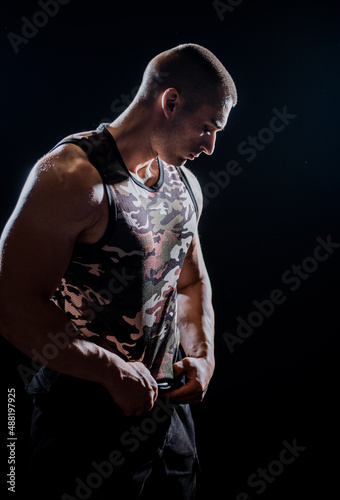Muscular man during workout in the gym