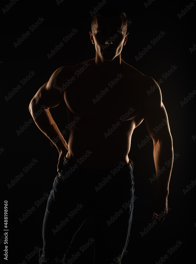 Fototapeta premium Portrait of topless guy posing and standing, silhouette