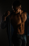 Posing with open shirt in studio while flexing, close up