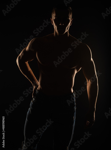 Portrait of topless guy posing and standing, silhouette © qunica.com