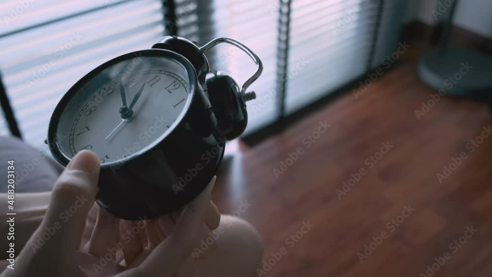 Setting clock back by 24 hours in room by women hand 4k