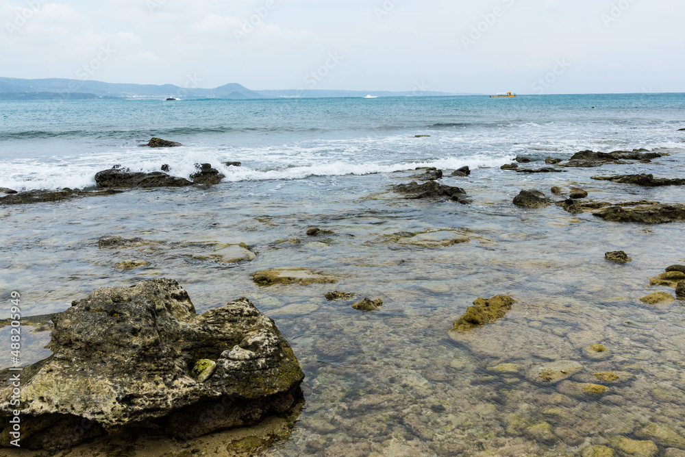 Sea splash over the rock and stone beach