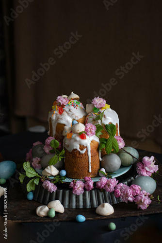 Dark Easter. Easter cakes and eggs with flowers. sakura, spring blooming