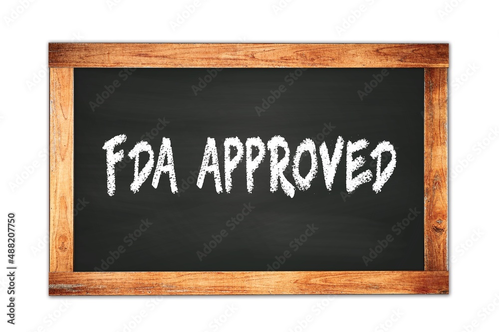 FDA APPROVED text written on wooden frame school blackboard. FDA APPROVED text written on wooden frame school blackboard.