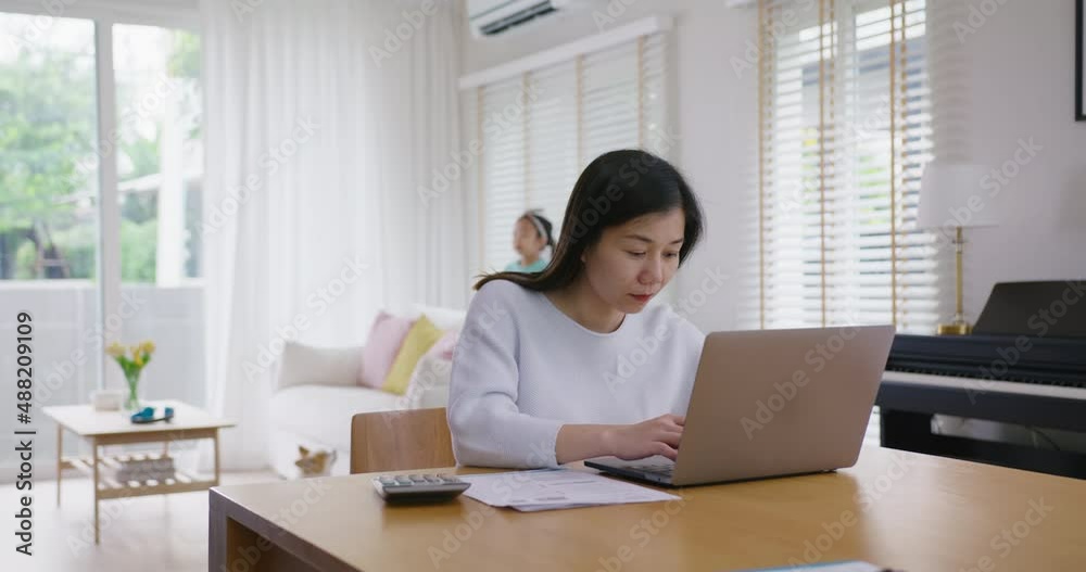 Adult asia people single mom small SME owner support happy sit busy apply child tax credit refund plan form app or pay loan bill on laptop. Little kid girl play at home hybrid job career workforce. Adult asia people single mom small SME owner support happy sit busy apply child tax credit refund plan form app or pay loan bill on laptop. Little kid girl play at home hybrid job career workforce.