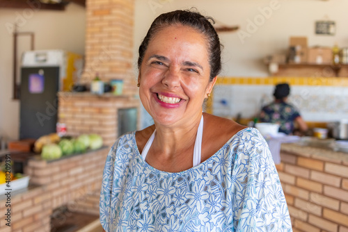 Hairstyled woman smiling at camera, narrow focus