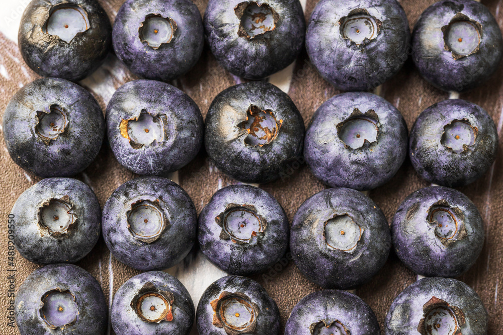 Naklejka premium Blue-purple blueberries on a black-white background. Blueberry still life.