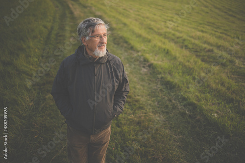 Senior man enjoying the outdoors  hiking  walking through lovely nature